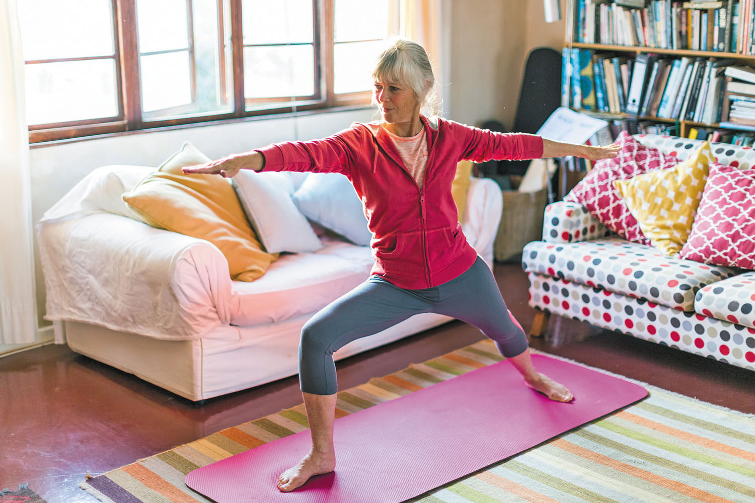 photo of a woman in a yoga pose in her living room